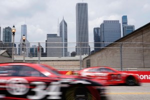 In-motion image of racecars with the Chicago skyline in the background