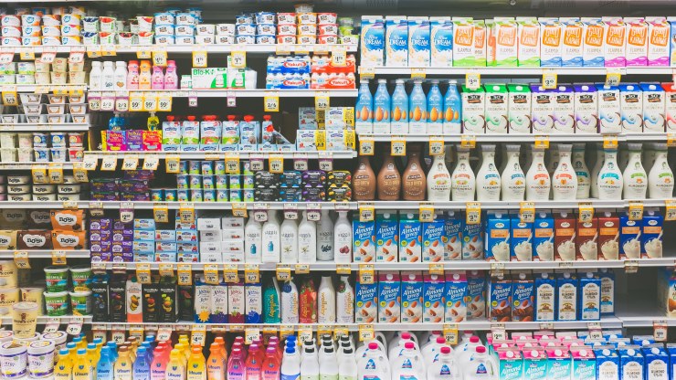 A shelve of dairy products at a grocery store.