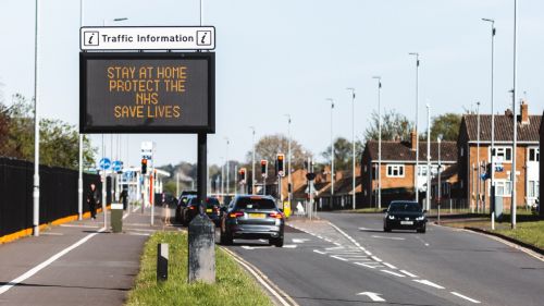 A sign in the UK calls for residents to stay home amid a new strain of COVID-19