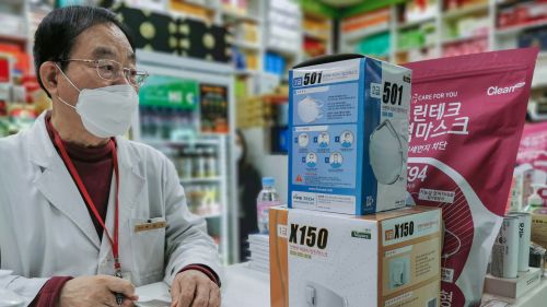 A pharmacist in Seoul ringing up masks. 