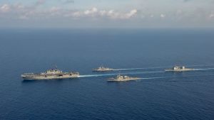 US Navy ships sail move through the Pacific