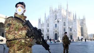 Military officers in face masks stand guard at the Duomo cathedral