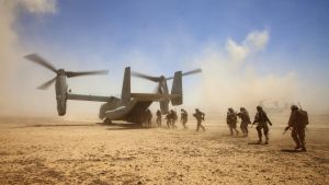 US troops board a plane in the desert in Afghanistan