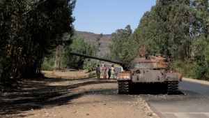 An armored tank drives down a paved path in Ethiopia