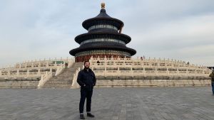 A person stands in front of the Temple of Heaven in China
