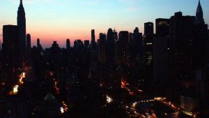Cars try to navigate through New York City as the sun sets during a blackout on Aug. 14, 2003.