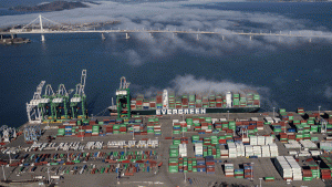 Shipping containers are unloaded from ships at a container terminal at the port of Oakland
