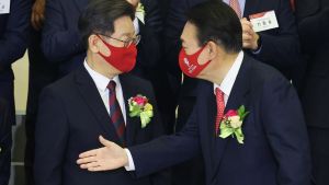 Yoon Suk-yeol, the presidential election candidate of South Korea's main opposition People Power Party (PPP), shakes hands with Lee Jae-myung, the presidential election candidate of the ruling Democratic Party.