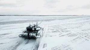 An armored tank drives through snow