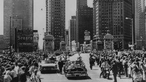 black and white wide shot of chicago skyline in 1959 with Queen Elizabeth II's motorcade in foreground.