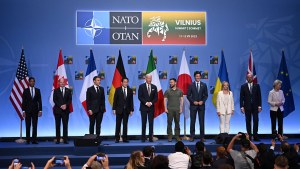 World leaders stand on stage at the NATO summit in Vilnius