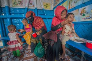 Mothers and their children at a center for Rohingya refugees in Bangladesh