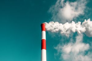 A smoke stack in front of a blue sky
