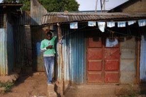 Man in Kenya reading his phone
