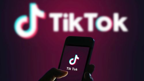 A person accesses the mobile app TikTok on their smart phone