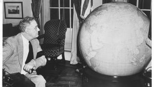 President Roosevelt examines a globe presented to him by the U.S. Army. December 25, 1942.