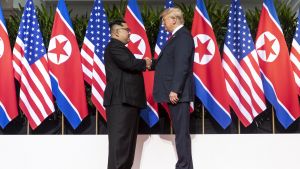 Kim and Trump shaking hands at the red carpet during the DPRK–USA Singapore Summit