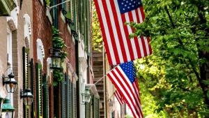 American flags outside brick houses