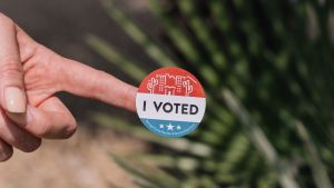 A person holds an I Voted sticker
