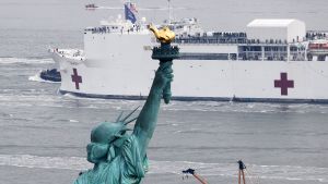 The USNS Comfort passes the Statue of Liberty