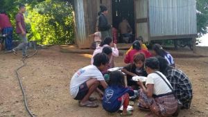 People displaced by fighting share a meal in Myanmar’s northwestern Chin State