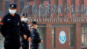 Guards in surgical masks stand in front of the Wuhan Institute of Virology