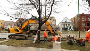 Workers prepare to replace older water mains in the 5100 block of West Roscoe Street 