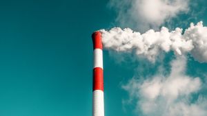 A smoke stack in front of a blue sky