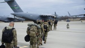 American troops line up to board an aircraft waiting to deploy to Ukraine in Fort Bragg.