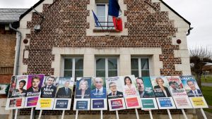 A brick house with presidential candidate posters on its exterior
