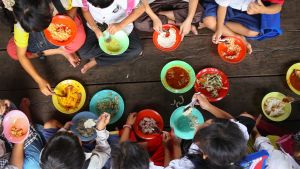 Children eat a school meal in Asia