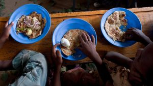 Children in school in Ethiopia eat a meal.