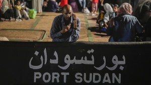 A Sudanese evacuee waits at Port Sudan before boarding a Saudi military ship