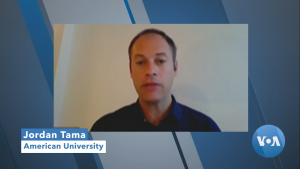 Screenshot of Jordan Tama speaking on VOA news with blue background