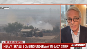 Screenshot of Ivo Daalder (right) with red background caption below, video of Israeli military truck in Gaza at right.