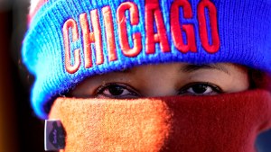 A person wearing a scarf and a hat with "Chicago" on it