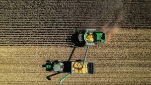 An aerial view of farm equipment harvesting a field